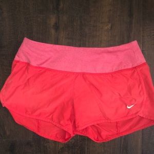 Pink Nike Dri-Fit athletic shorts
